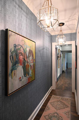 Wallpaper from Maresca Textiles in the hall provided the perfect backdrop for Gregg Irby’s personal art collection