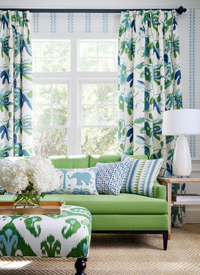 Agave Stripe wallpaper. Draperies in Matisse Leaf printed fabric. Dixon Sofa with Buttons in Prisma woven fabric. Pillows (Left to right): Elephant Velvet, Plaza, and Lomita Stripe printed fabric. Baxter Bench in Indies Ikat printed fabric. 