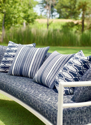 Chair cushion in Cestino woven fabric. Pillows in Saraband and Kaia Stripe woven fabric. 