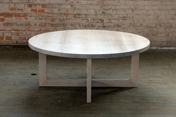 Solid wood from the urban forest imbues this round wood coffee table in our Shoals finish with unique grain and texture. 