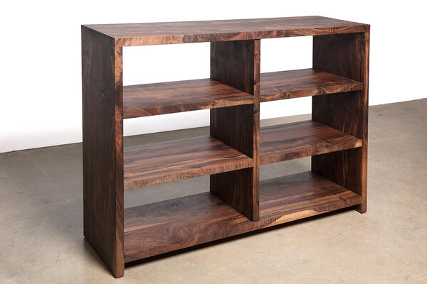 The beautiful Walker, wooden bookshelf, is a great addition to any room in a house. Both functional and stylish, the unique wood grain of eco-friendly wood is shown off in this modern shelving unit. 