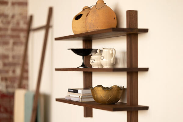 This Floating Shelving Unit offers a new and modern take on Mid-century wall storage. Defined by sturdiness and minimalism, this Still Life floating shelving unit is available in natural walnut or stained oak. 