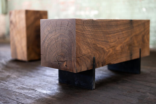 This dark walnut wood bench is made from reclaimed urban wood. Primitive beauty with an urban touch. The solid wood bench utilizes salvaged walnut wood logs for a rustic bench feel. Narrow and backless, the simple lines express the natural texture of the end grain of each species. 
