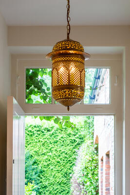 Inspired by Moorish designs from the 17th century, the highly decorative Adhurst lantern in brass features hand-pierced fretwork