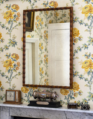 Based on an antique dressing table mirror, the Regency-inspired Crofton mirror is decorated in a faux bamboo finish