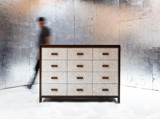 Abuelo bureau: A marriage of luxurious textures, Abuelo is rugged modernism at its best. Coquille d’Oeuf, hand-cracked eggshells embedded in resin and lacquer, adorn drawer faces and the blotter in its newest iteration. Traditional leather faces in DLV leather or COL are also a timeless choice