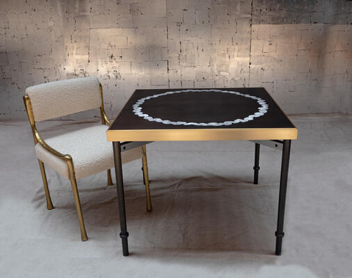 Couronne game table: Inspired by the work of art deco master Maxime Olde, the Couronne game table showcases a harmony of intersections. The base is a mix of metals: gunmetal steel, brushed aluminum stretchers, and screw details in polished brass. Dark, smooth resin grounds the elegant embedded Coquille d’Oeuf (eggshell mosaic) top, which is trimmed by a satin brass frame