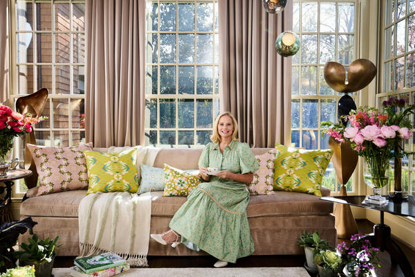 Accent pillows in English Garden patterns include (left to right): Primrose Mauve, English Garden Citron, Dorset Garden Blue, Lady Di Yellow. Laura Park is wearing the Brooks Avenue Banyan Street puff sleeve dress in Starry Night Blue