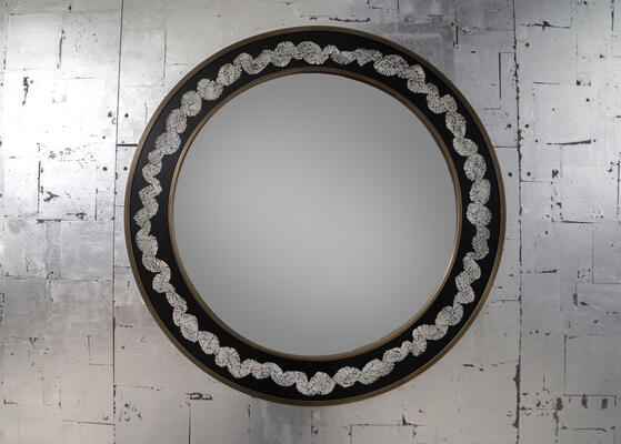 Couronne mirror: Hand-cracked eggshell embedded into resin and lacquer “crowns” the frame of this regal mirror