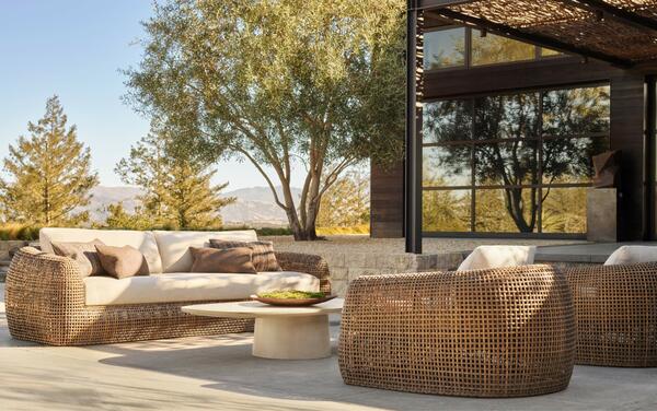 Gemini seating in all-weather wicker shown with the Caprera concrete coffee table