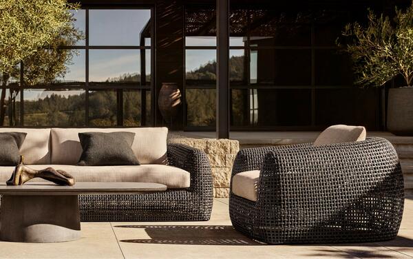 Gemini seating in all-weather wicker shown with the Caprera concrete coffee table