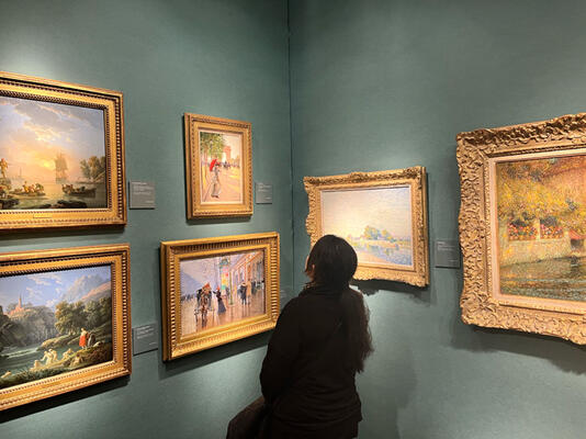 Loida Lafi takes in a selection of impressionist paintings on display at the Richard Green booth