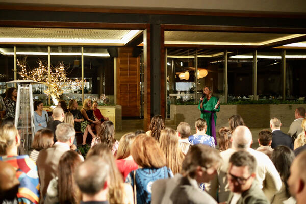 Patty Dominguez, vice president of business development, spoke to guests during the cocktail hour before the welcome dinner
