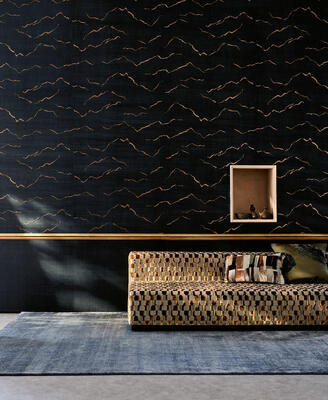 In the Kuju wallcovering, fluid metallic lines gracefully capture the essence of simplicity, drawing inspiration from a majestic landscape that exudes a profound sense of tranquility. Printed on a ground that mimics the appearance of fine silk, this design is created using an innovative foam for depth and overlaid with a metallic foil for a touch of luster