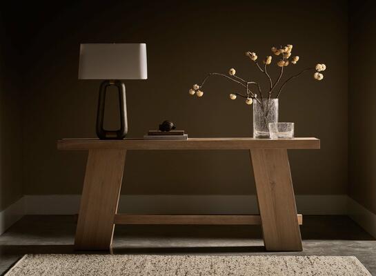 The Altitude console is a craftsman-inspired table comprising exposed joinery and rectilinear forms paired with a heavily sandblasted but warm knotty oak veneer top
