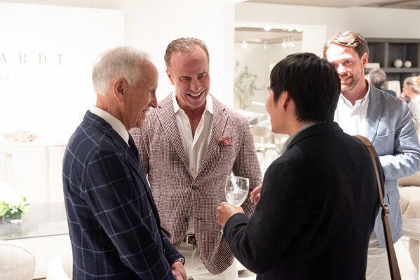 Alex Bernhardt Sr., Alex Bernhardt Jr. and Bernhardt Exteriors merchandise manager Matt Wiley chat with a party guest