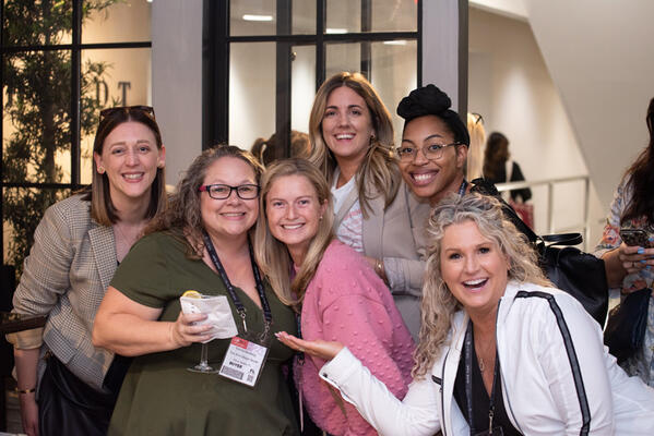 Victoria Sandberg (center) of Toni Sims Design Studio in Winter Garden, Florida, celebrates with friends and associates after hearing her name drawn for the trip to Mexico 