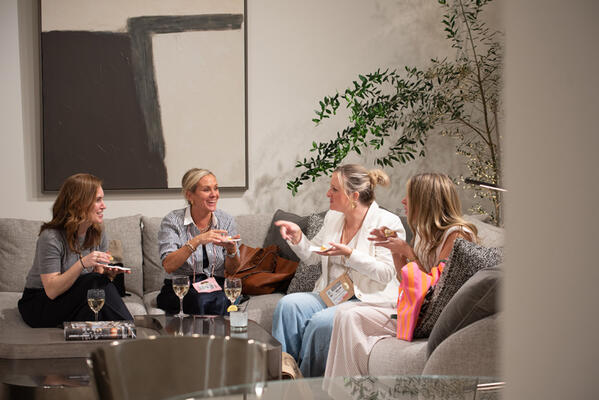Associates from Stephanie Kraus Designs in Wayne, Pennsylvania, enjoy cocktails and snacks on the Bernhardt Moretti sectional