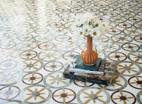 Margherita, a waterjet-cut mosaic, shown in honed Calacatta Monet, polished Red Lake, Giallo Reale and Oyster