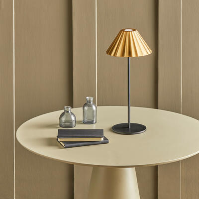 Twinky cordless table lamp in black with an antiqued brass shade