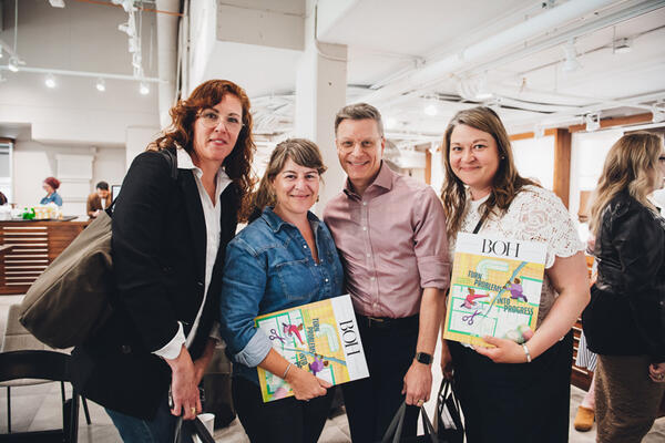 Attendees pose with copies of BOH magazine