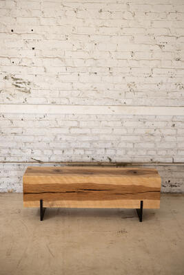 The 12" x 12" beam is milled and finished to sit raised by a mild steel base with a black patina. The hickory beam bench can be fabricated to order, in a variety of lengths up to 8 feet.