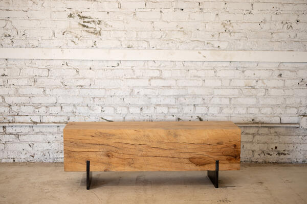 Carefully carved from reclaimed city wood, this exquisite beech wood bench radiates a primal yet elegant allure. Incorporating rescued beech wood logs, the bench highlights the understated grain and texture of each variety in its sleek and armless construction. Indulge in rustic opulence with this unique masterpiece.


