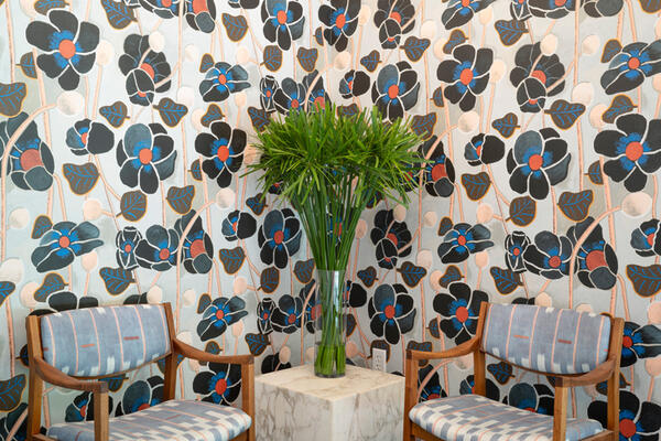 Graphic wallpaper and upholstery envelop the entrance of the Twenty2 studio