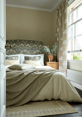 Strawberry Thief fabric headboard with Marigold Tree embroidered window treatments