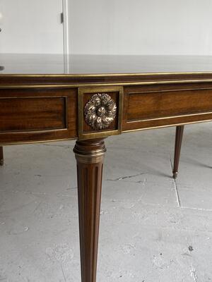 Gilded details and custom-cast brass mounts of the Louis XVI–style dining table