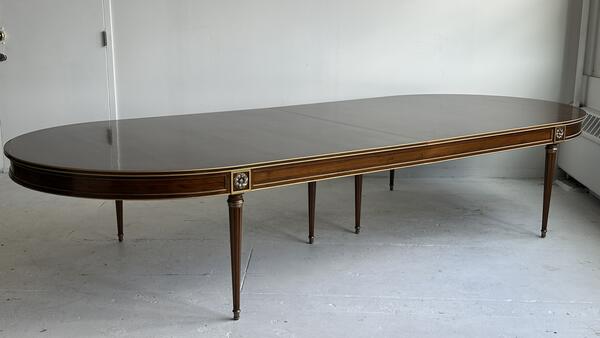 A much larger, custom version of the Louis XVI–style dining table