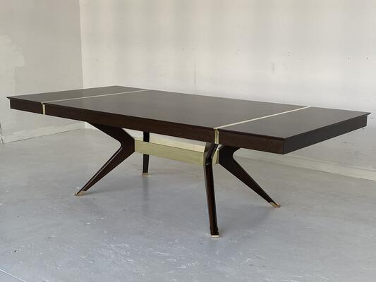 A custom modernist dining table incorporating leaf storage 