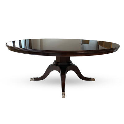 Perrault dining table in a dark mahogany stain with nickel-plated shoes