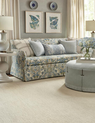 Aspen rug; Clarkson weave wallcovering; draperies in Beckley Stripe fabric; Addison sofa in Narbeth fabric; pillows in Lindsey and Ensbury Fern fabrics; Wyndham ottoman in Bailey with trim in Holden Stripe and Belinda tape 