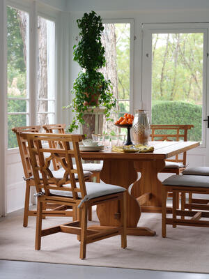 Our outdoor teak Lewis Armchairs and Side Chairs surround our Graham Dining Table.