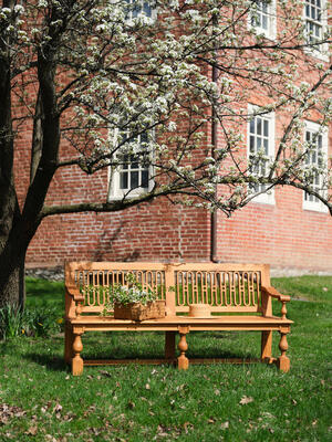 Our outdoor teak Kingston Bench is inspired by the historic benches of Versailles. 