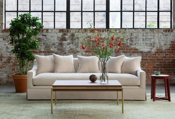 A handsome, modern skirted sofa with sloped arms, the Grant sofa is great for lounging