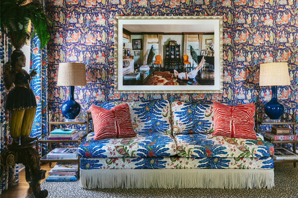 Shalimar wallpaper in Navy/Red behind the Sherwood sofa upholstered in Riviere in Blue