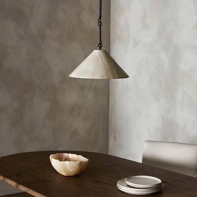 Crafted from solid marble shaped into a tapered cone, the Concetta pendant diffuses a naturally luminous glow