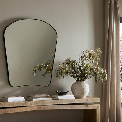 The Merona mantel mirror’s swooped silhouette creates rounded corners while maintaining a sleek overall look