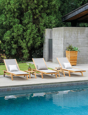 Summit teak chaises in Taupe with Summit side tables and Studio teak planter