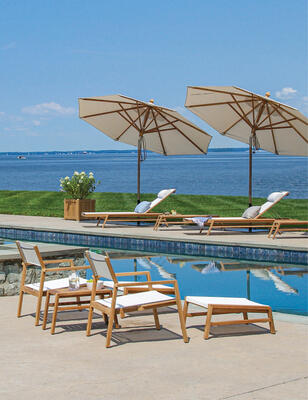 Summit teak lounge chairs with ottomans and chaises in Cloud with tilting teak umbrellas