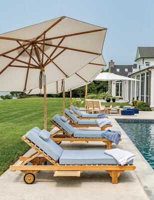 Shelbourne teak chaises with tilting teak umbrellas