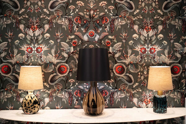 A showroom vignette featuring Moooi for Arte and Porta Romana lighting on a Powell and Bonnell console