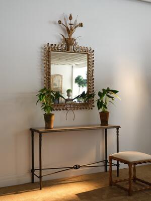 The Baron console table features a striking inset stone top and metal base 