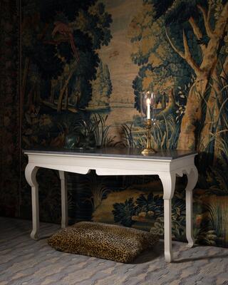 This white hooked-leg console has a faux painted stone top 