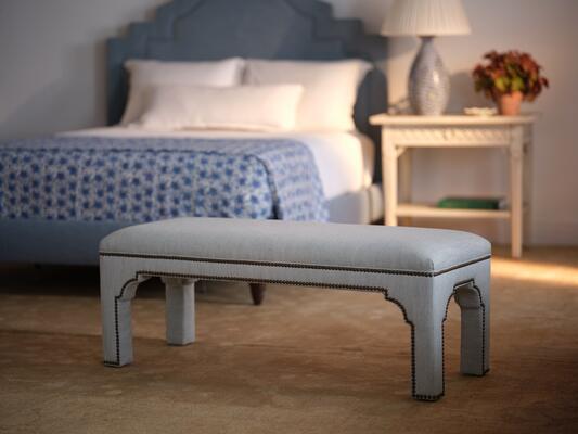 A Mughal-inspired arch and French nailhead trim make this bench a standout in style