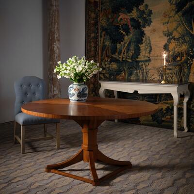 The Tedrick dining table showcases a stunning radiating chevron-star pattern