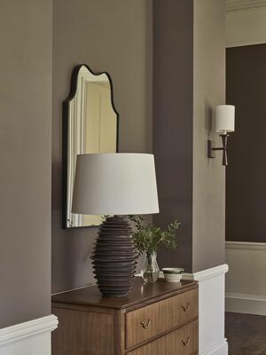 The Milland table lamp, Hensting mirror in bronze and Lancing wall light create a pleasing tableau