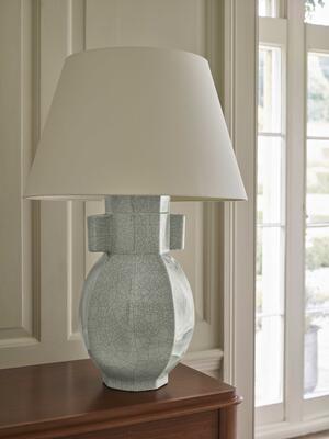 The faceted baluster of the Hannington table lamp is adapted from a petite antique Longquan ceramic vase